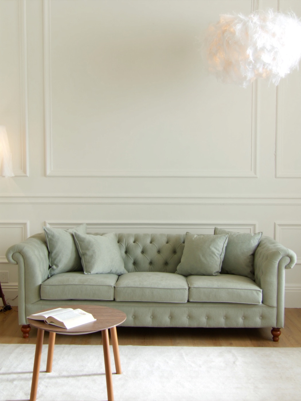 A bright, welcoming therapy room with a sage green couch